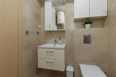 a bathroom with a white sink and a toilet at DM Apartments in Kotor