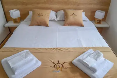 a bedroom with a bed with towels on it at DM Apartments in Kotor