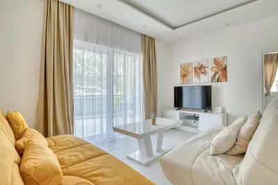 a living room with a couch and a tv at The Golden Luxury Apartments in Kotor