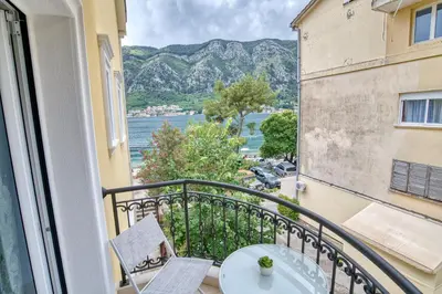a balcony with a table and chairs and a view at The Golden Luxury Apartments in Kotor