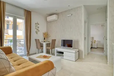 a living room with a couch and a tv at The Golden Luxury Apartments in Kotor