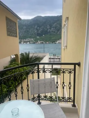 a balcony with a table and a view of the water at The Golden Luxury Apartments in Kotor