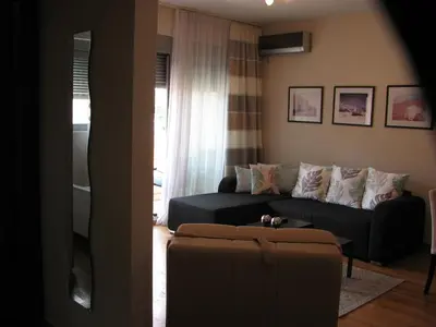 a living room with a couch and a table at Apartment B&S in Budva