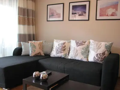 a living room with a couch with pillows and a table at Apartment B&S in Budva