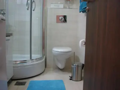 a bathroom with a toilet and a glass shower at Apartment B&S in Budva