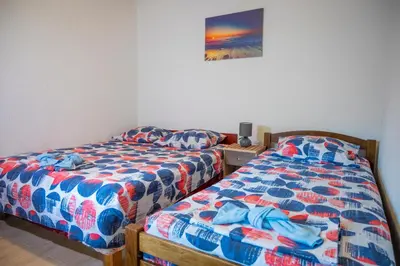 two beds sitting next to each other in a bedroom at Vikendica Luka in Čanj