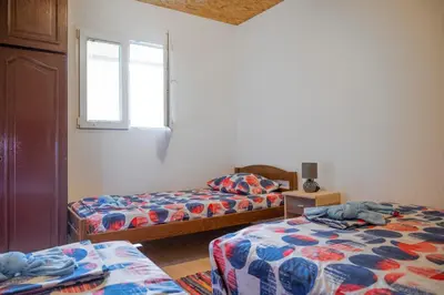 a bedroom with two beds and a window at Vikendica Luka in Čanj