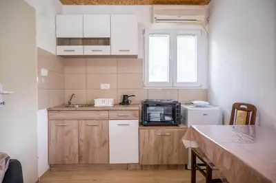 a small kitchen with a sink and a microwave at Vikendica Luka in Čanj