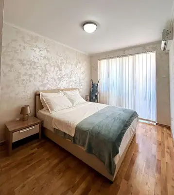 a bedroom with a large bed and a large window at V Lux Apartment Sveti Stefan in Sveti Stefan