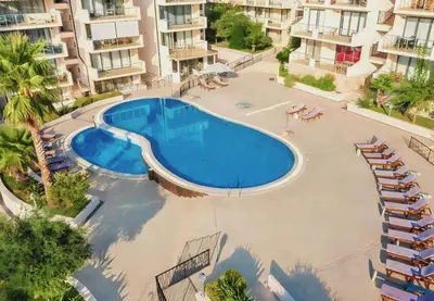 an overhead view of a swimming pool in an apartment complex at V Lux Apartment Sveti Stefan in Sveti Stefan