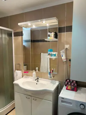 a bathroom with a sink and a mirror at V Lux Apartment Sveti Stefan in Sveti Stefan