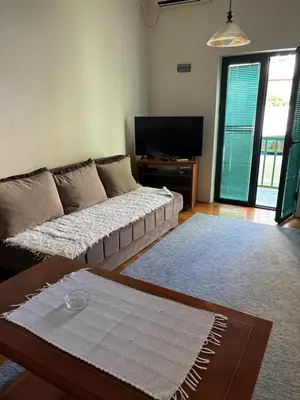 a living room with a couch and a table at ILIC APARTMENTS in Budva