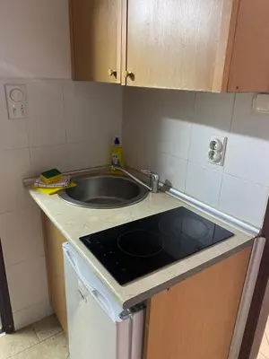 a kitchen with a sink and a counter top at ILIC APARTMENTS in Budva