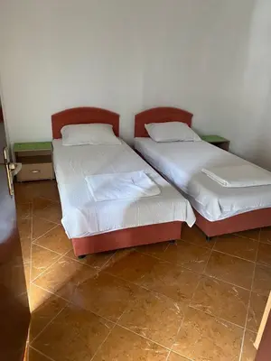 two beds sitting next to each other in a room at ILIC APARTMENTS in Budva