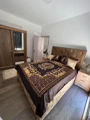 a bedroom with a large bed in a room at Glamur Apartman - Ulcinj in Ulcinj