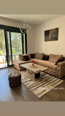 a living room with a couch and a coffee table at Glamur Apartman - Ulcinj in Ulcinj