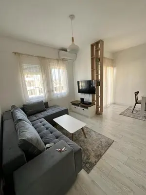 a living room with a couch and a table at Eastside studio in Podgorica