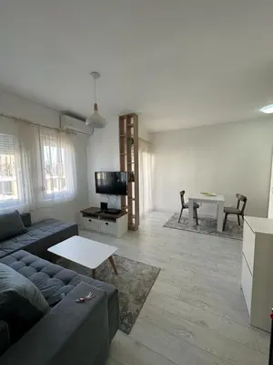 a living room with a couch and a table at Eastside studio in Podgorica
