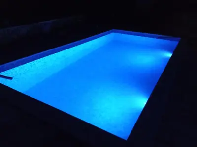 a pool with blue light in a dark room at Lapčiči View in Budva