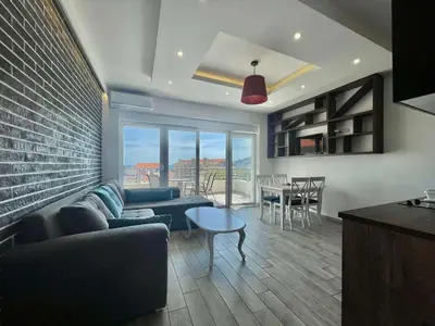 a living room with a couch and chairs and a table at Bucanero Apartments Budva in Budva