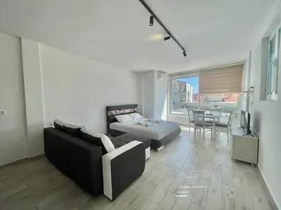 a living room with a couch and a table at Bucanero Apartments Budva in Budva