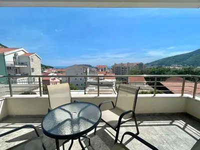 a balcony with a table and chairs and a view at Bucanero Apartments Budva in Budva