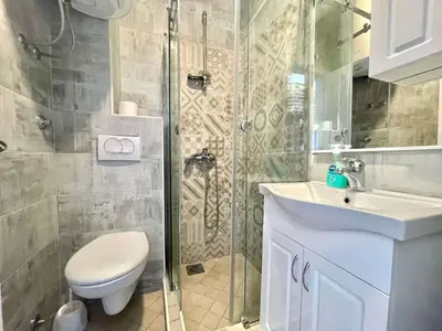 a bathroom with a shower and a toilet and a sink at Bucanero Apartments Budva in Budva