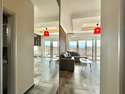 two views of a living room and a dining room at Bucanero Apartments Budva in Budva