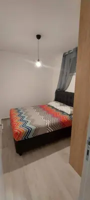 a bed with a canopy in a room at Biser Apartmani in Podgorica