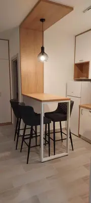 a kitchen with a table and chairs in a room at Biser Apartmani in Podgorica
