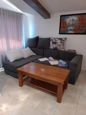 a living room with a couch and a coffee table at TLM Apartments in Budva