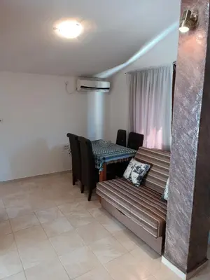 a living room with a couch and a table at TLM Apartments in Budva