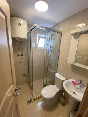 a bathroom with a shower and a toilet and a sink at Apartmani Resetar in Sutomore