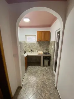 a kitchen with a sink and a counter top at Apartmani Resetar in Sutomore
