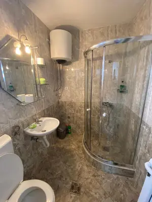 a bathroom with a shower and a toilet and a sink at Apartmani Resetar in Sutomore