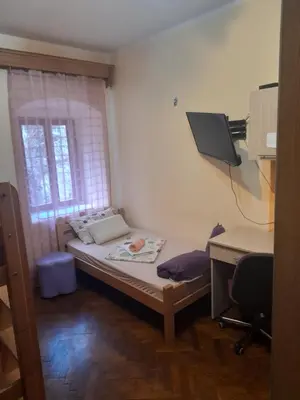 a small bedroom with a bed and a desk at Centar Starog Grada in Kotor
