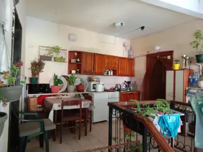 a kitchen with wooden cabinets and a table with chairs at Centar Starog Grada in Kotor