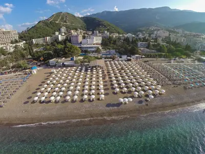 a large group of umbrellas on a beach at Hotel Tara Becici in Budva