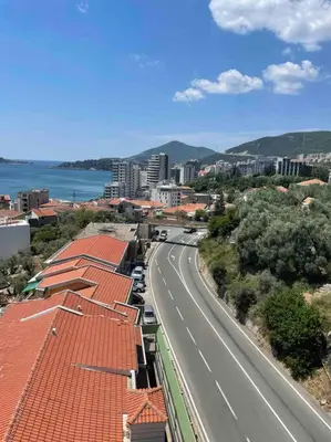 a city with a street and a road with buildings at Golden Details Apartment in Rafailovici