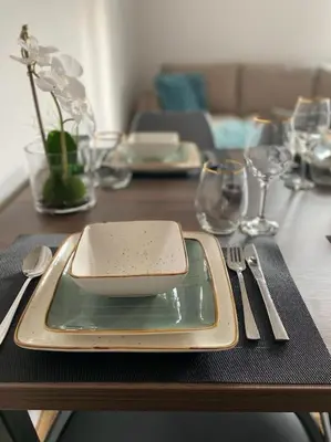 a table with a plate with a bowl on it at Apartment Olivia in Becici