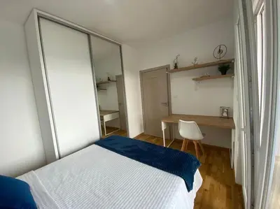 a bedroom with a bed and a desk and a mirror at Apartment Olivia in Becici