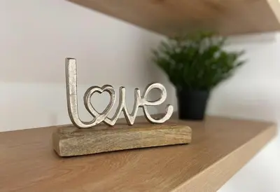 a wooden sign that says love sitting on a table at Apartment Olivia in Becici