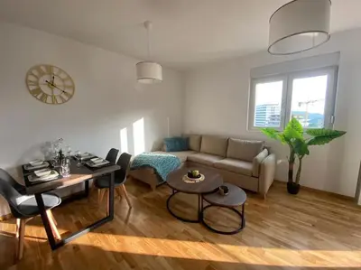 a living room with a couch and a table at Apartment Olivia in Becici