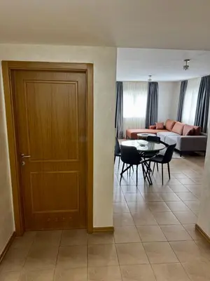 a living room with a door and a table and chairs at Seaside Apartment in Becici in Budva