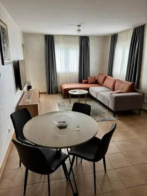 a living room with a table and a couch at Seaside Apartment in Becici in Budva
