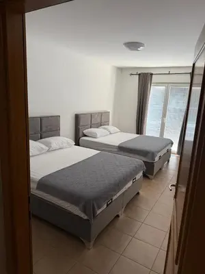 three beds in a room with a window at Seaside Apartment in Becici in Budva