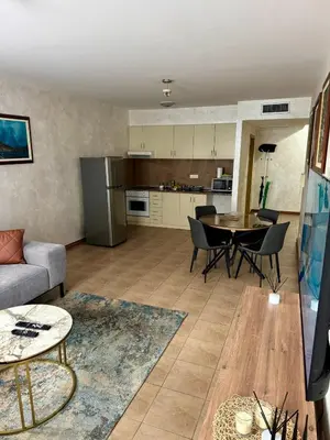 a living room with a couch and a table at Seaside Apartment in Becici in Budva