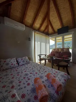 a bedroom with a bed and a living room at Old house7 in Bar