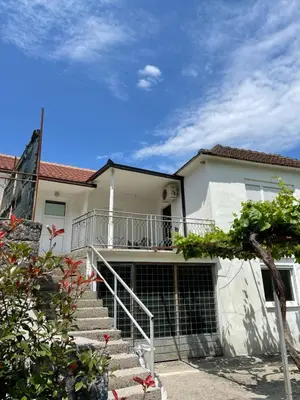a white house with stairs in front of it at Honey Home in Podgorica