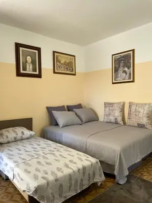 two beds sitting next to each other in a room at Honey Home in Podgorica